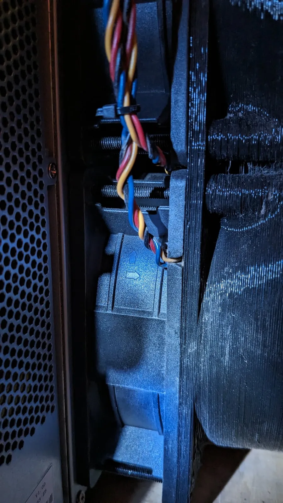 The miner’s stock fans seen through the case, still mounted in front of the duct adapter